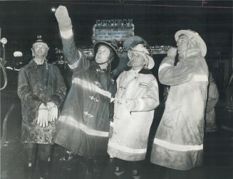 Fire Chiefs Arnold Watson of Lindsay and Paul Brown of Peterborough (in light suit at right) confer with firemen from Omemee and Lindsay departments a(...)