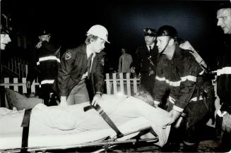 Blaze tragedy. Top, victim of early morning fire on Caroline St. being taken by fire and ambulance personnel. Firemen (left) try to revive a victim br(...)