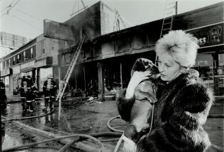 Little Hero: Jennifer Zilberleib says her dachshund's barking went a long way toward ensuring she and three children escaped the fire that gutted an auto body shop beneath their apartment yesterday