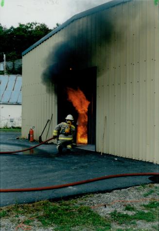 Just a test: A firefighter puts out a blaze ignited at the Ontario Fire College in Gravenhurst to simulate fire conditions at a Mississauga retirement home