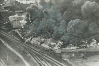 Flames belch 100 feet into the air from the warehouses