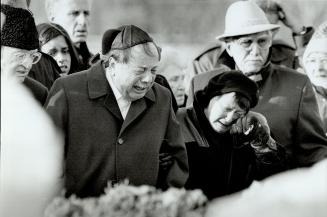 Stewart Arthur Scheinert's father Murray and mother Nettie weep yesterday at their son's burial, attended by 400