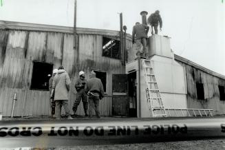 Suspect furnace: Fire investigators examine a furnace at the east end of the raceway barn where some thought the fire had started