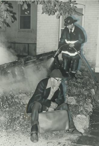 A fire? So what. Elderly resident of a Jarvis St. apartment building appears resigned as a firefighters douses a burning chesterfield dragged from the(...)