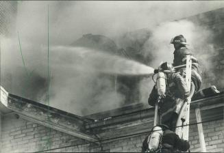 Man and machine: Above, fire fighters struggle to bring a blaze under control
