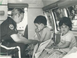 Breath of life. James Biso, 4, gets oxygen paramedic Glen Ruppei after he, his 2-year-old sister, Tricia, and their father, Bruce, were rescued from t(...)