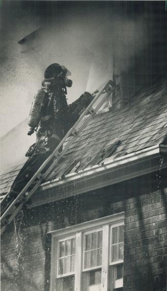 A steady hand. As cold water showers down around him, a firefighter keeps his high-pressure hose trained on flames coming from the roof of a burning h(...)
