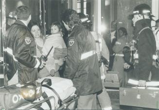 Close call. Emergency crews help a mother and daughter last night after the girl was rescued from a smoke-filled condo on the fifth floor of a highris(...)