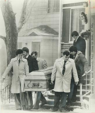 Coffin of miner Fabian Ward is carried from Glace Bay funeral home during service today