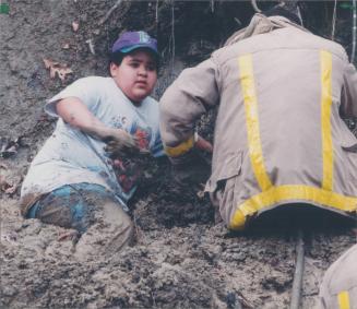Adam Spence and firefighter Scott Parker stuck in mud