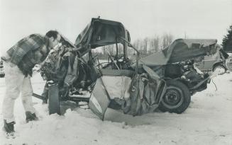 One man died in the twisted wreckage of this, car, sandwiched between the rear of an Ontario Northland bus and another car in Sunday's 33-vehicle pile(...)