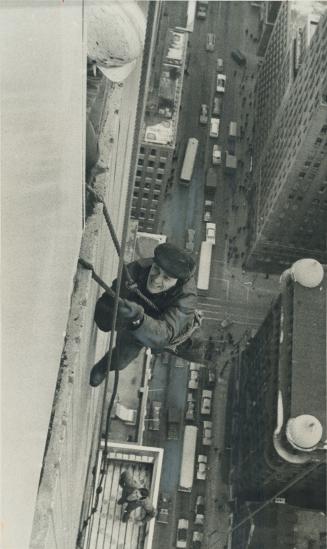 One wrong move could have been fatal to Marion Niewada, who was working on a scaffold that stuck 400 feet up the Simpson Tower at Queen and Bay Sts