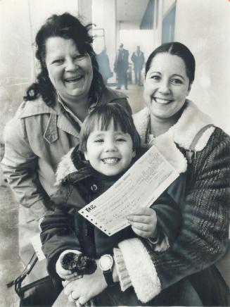Happy claimants: Christine Fleet, left, and Charlene Campbell, with her son, Billy, 3, were among hundreds of evacuees pleased with cheques they got from CP Rail yesterday for expenses