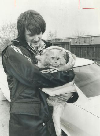 A feline rescue: Mark Hennick, whose home is still in evacuation area, was allowed in by police to rescue family's cat, Buffy, who had been left behind 3 days ago