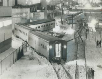 Three CNR cars derailed last night in Weston and 14 persons were injured -- one when a fence post pierced her abdomen
