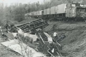 10 tons of beef spilled. Wreckage litters ravine after three flatcars carrying trucks loaded with beef jumped CN tracks just east of Don Valley Parkwa(...)