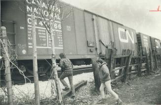 (Left) John Larm check fence near the spot brother Robert, 14, fell under train