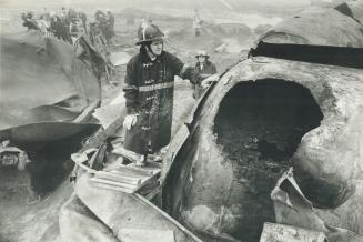 Fireman examines hole in chlorine tanker that forced evacuation of Mississauga residents