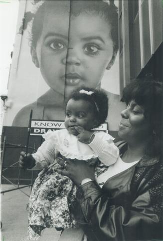 Wendy Cole holds her 14-month-old daughter, Dominique Lauren, in front of a billboard that features a painting of the tot in a new Labatt Breweries ca(...)