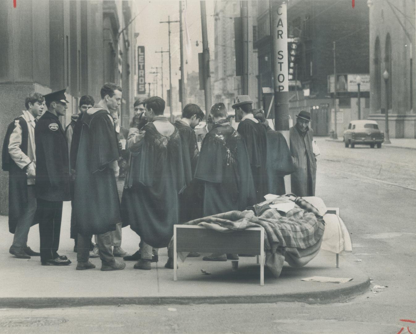 April Fool at King and Bay. King and Bay Sts. seems hardly the place for a nap on cool spring morning but Gordon Jackson of Trinity College appears un(...)