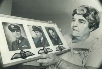 A mother never forgets. Silver Cross mother Mrs. George Stephens holds the pictures of her three sons, who were killed in World War II: (from left) Jo(...)