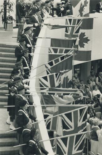 War dead recalled: Flags held by veterans and others form a swaying canopy over people attending a Remembrance Day ceremony at the Scarborough Civic Centre
