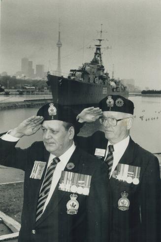 We remember: With the destroyer Haida in the background, Mike Small, left, and Martin Venman salute fallen comrades