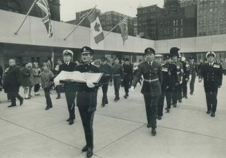 Remembrance book moved. The golden Book of Remembrance, which contains names of Torontonians killed on active service, is carried in solemn procession(...)