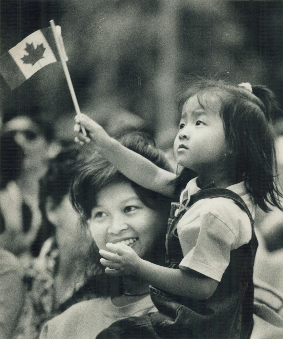Held up above the crowd marking Canada Day at Queen's Park yesterday, this little girl takes a serious view of the patriotic proceedings. An estimated(...)