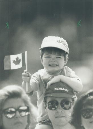Kid's eye view: Jamie Waring, 2 1/2, has a good seat for the Canada Day stage show at Queen's Park yesterday thanks to dad Michael Waring