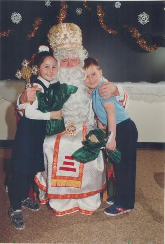Ukrainian Christmas tradition. St. Demetrius Separate School students Natalie Falcomer, 5, and Mykola Turczyn, 4, celebrate St. Nicholas Day, when the(...)