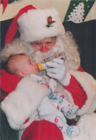 Having a snack with Santa. Santa was nabbed for double duty when Charles Mason, three months, of Mississauga came calling at Sherway Gardens with mom (...)