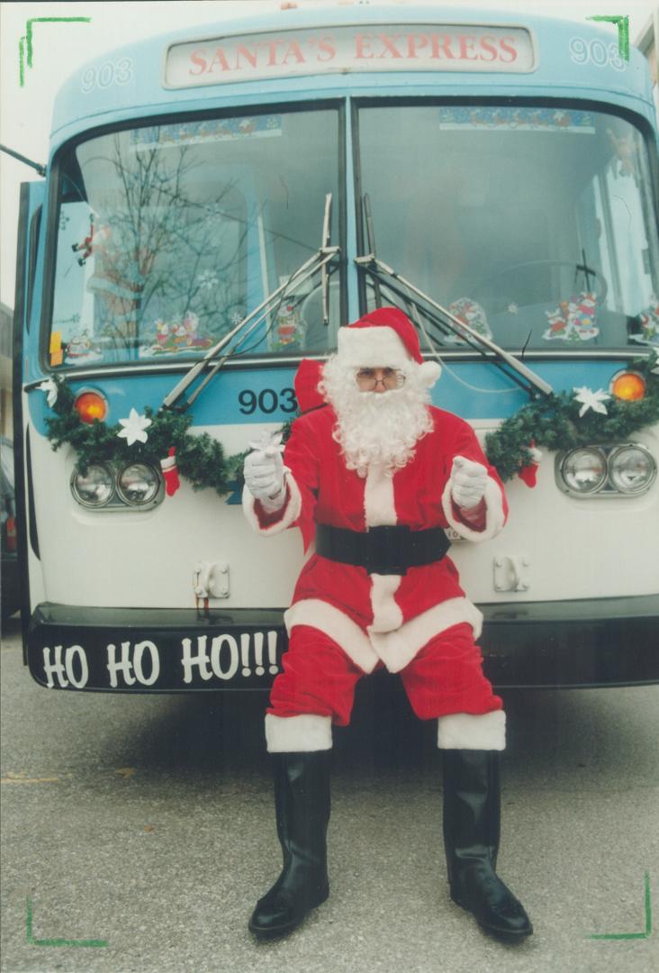 Santa perches in front of Ajax Transit's special Christmas but which, with Santa at the wheel, picks up toys for charity and visits homes for the aged