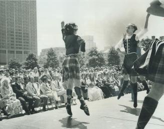 Three young girls perform the Highland Fling in front of an audience that includes Prime Minist ...