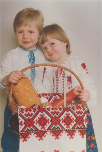 Sharing Easter blessings. Anastasia Hare, 2, and brother Patrick, 4, put all their eggs in one basket to be ready for Easter on Sunday. Their basket o(...)