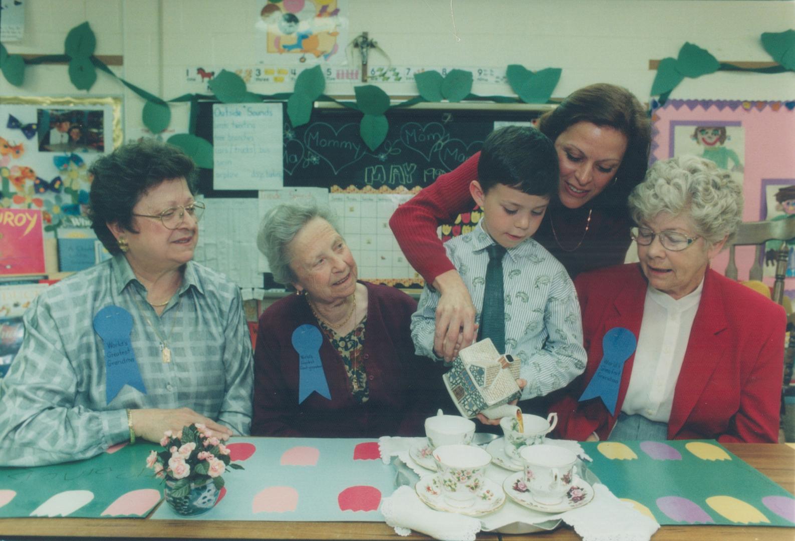 Rosemary Ayling helps her son Francis, 4, serve tea to his grandmothers Teresa Canaletti, left and Maureen Ayling, far right, and to his great-grandmo(...)