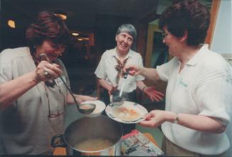Seder celebration: Susan Rosenstein, Daybreak's Beth Porter and Anne Glickman serve the traditional chicken soup