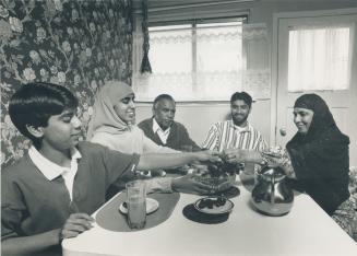 The Nawaz family prepares to break their fast for the day during Ramadan, left to right, Muddaththir, 12, Zarqa, 20, father Ali, Muzammil, 19, and mother Parveen
