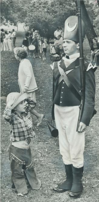 Gunflighter meets a trooper. A pioneer and military pageant highlighted celebrations of Simcoe Day yesterday at Todmordon Mills on Pottery Rd. Cowboy (...)
