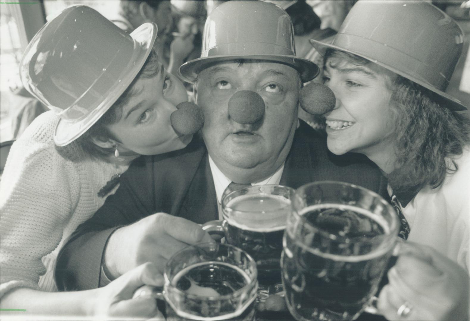 Who 'nose' best? Giselle Amann, left, and Joanne Tiahnybok have a peck on the cheek and a toast for Frank Haines yesterday at a Metro pub -- all to pr(...)