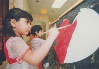 Heartfelt concentration. Maria Chung, in the senior kindergarden class at Burrows Hall Junior public school, concentrates as she paints a gigantic Val(...)