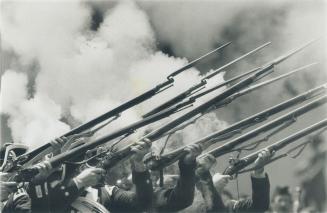 Firefarm fireworks: Troops of the musket-bearing King's Royal Regiment of New York fire their guns in salute during this year's Victoria Day parade in Metro