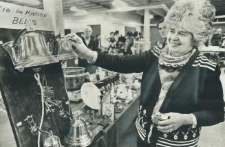 Spit 'n' polish. Peggy Rogers of Mississauga adds the final burnish to the ship's bells in her display in the weekly flea market and antique sale at H(...)