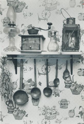 Early kitchen tools, lamps decorate kitchen