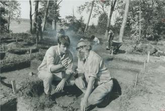 D. M. Hall and Walter Kenyon. Principal and museum curator examine find