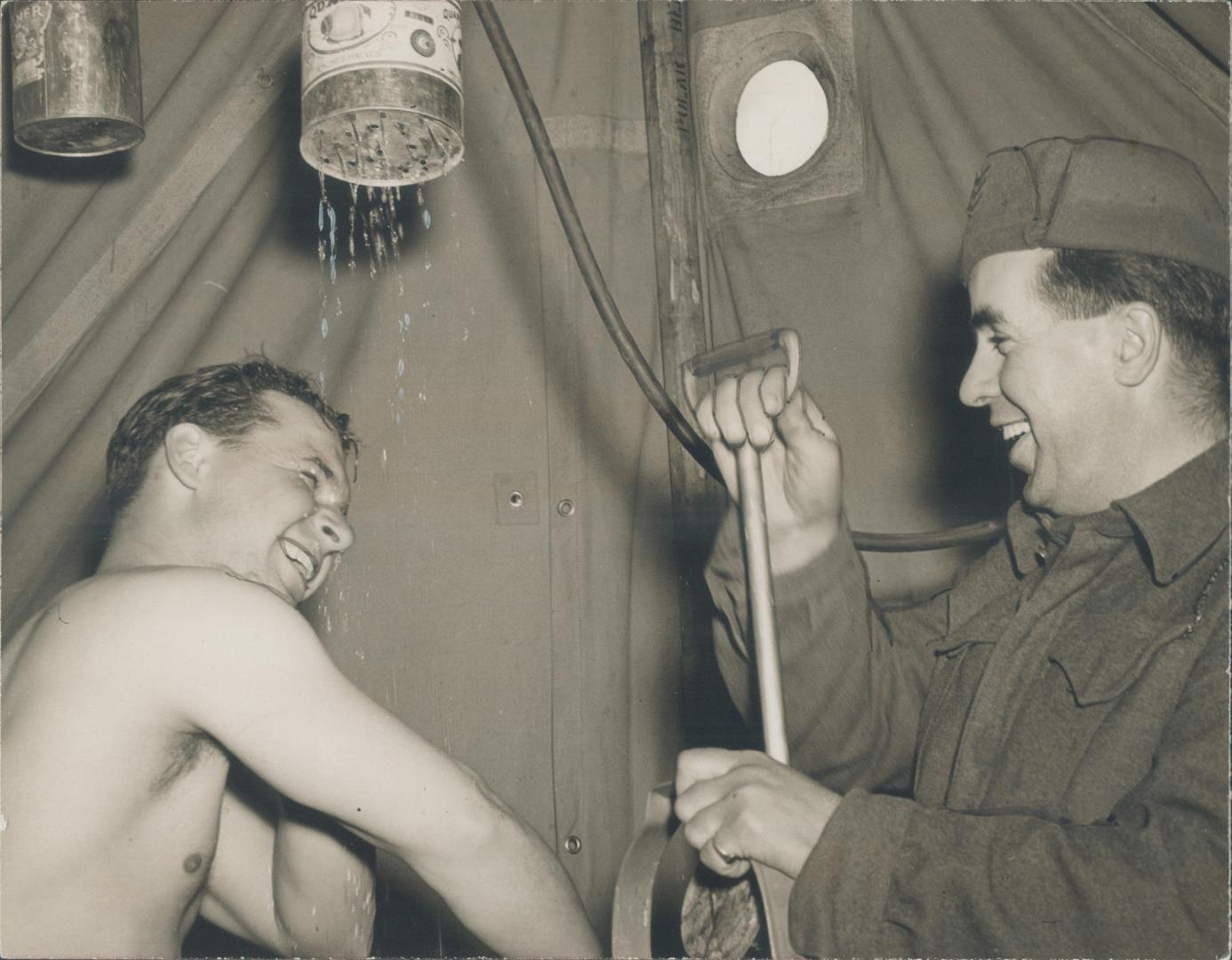All the comforts of home, says Robert Kupchynsky, Toronto, as he showers under a tin can full of holes