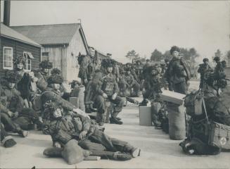 Canadian Paratroopers in full battle order are grouped on the unit's parade square in England, prior to moving on to the concentration area for the in(...)