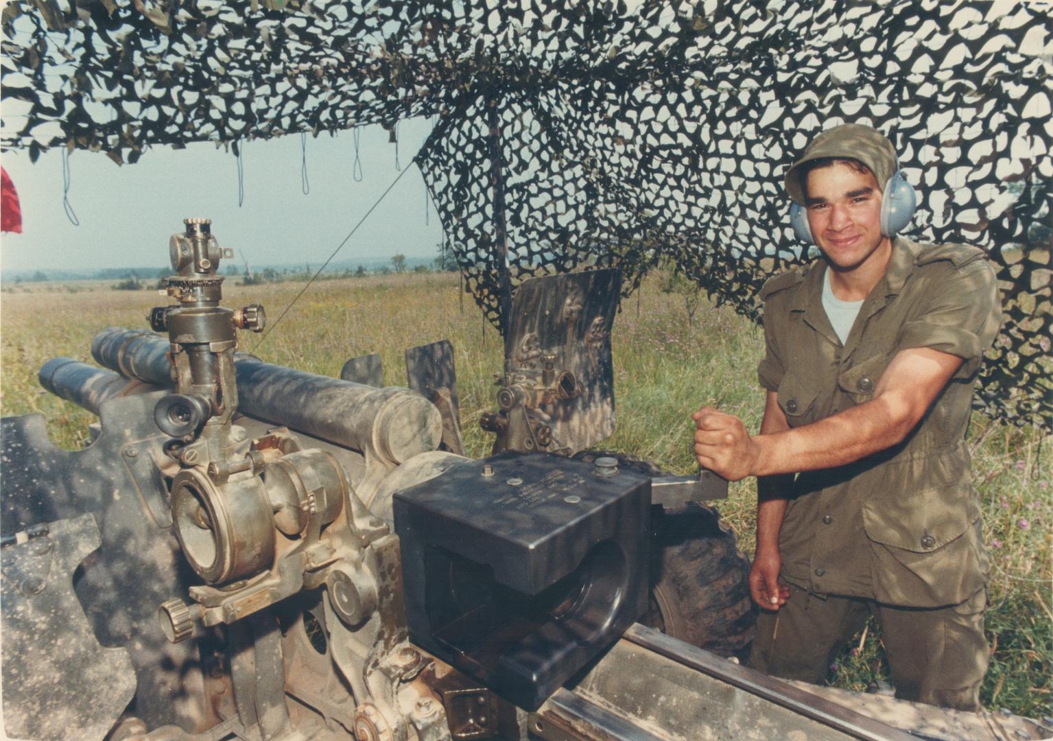 Ready, aim . . . Pte. Tarek El-Kaissi of North York prepares to fire a 105-millimetre Howitzer during militia artillery training at Meaford. Live shells are used during the practice sessions
