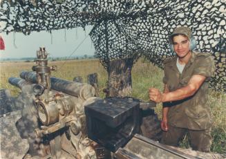 Ready, aim . . . Pte. Tarek El-Kaissi of North York prepares to fire a 105-millimetre Howitzer during militia artillery training at Meaford. Live shells are used during the practice sessions