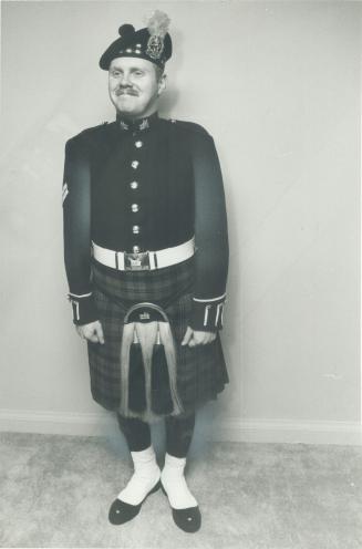 Regimental pride: Corporal Geoffrey Smith of Brampton shows the costly ceremonial dress worn by the Lorne Scots